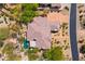 An aerial view showcases the roof, pool, and desert landscaping of this beautiful home at 9534 E Monument Dr, Scottsdale, AZ 85262