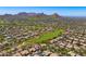 Aerial view features the community, golf course, homes and mountain views at 9534 E Monument Dr, Scottsdale, AZ 85262