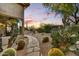 Desert landscaping and stone pathway create a serene and inviting outdoor space for relaxation and enjoying the sunset at 9534 E Monument Dr, Scottsdale, AZ 85262