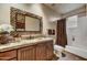 Charming bathroom with a decorative mirror and tile countertops at 9534 E Monument Dr, Scottsdale, AZ 85262