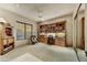 Spacious bedroom featuring a built-in bookcase and neutral carpet at 9534 E Monument Dr, Scottsdale, AZ 85262