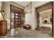 Foyer featuring a wooden front door, tile flooring and view into living area at 9534 E Monument Dr, Scottsdale, AZ 85262