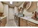 Well-lit laundry room with modern stainless steel appliances and ample counter space at 9534 E Monument Dr, Scottsdale, AZ 85262