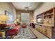 Cozy living room with comfortable seating, built-in shelving, and natural light from a window at 9534 E Monument Dr, Scottsdale, AZ 85262