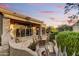 Outdoor patio with cozy seating, grill and lush desert views at twilight at 9534 E Monument Dr, Scottsdale, AZ 85262