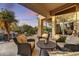 Covered patio area with comfortable seating and a view of the pool and waterfall at 9534 E Monument Dr, Scottsdale, AZ 85262