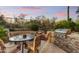 Outdoor patio with a stainless steel grill, fire pit, and comfortable seating at 9534 E Monument Dr, Scottsdale, AZ 85262