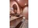 Unique powder room with textured walls, decorative tile flooring and an ornate sink basin at 9534 E Monument Dr, Scottsdale, AZ 85262
