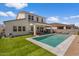 Home exterior with a pool, artificial turf and outdoor seating at 10144 E Toledo Ave, Mesa, AZ 85212