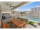 A picnic bench overlooks the backyard and sparkling pool at 10144 E Toledo Ave, Mesa, AZ 85212