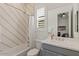 Modern bathroom featuring a shower-over-bath, and shuttered window over the toilet at 10144 E Toledo Ave, Mesa, AZ 85212