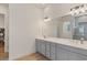 Bathroom featuring double sink vanity with modern fixtures and a large mirror at 10144 E Toledo Ave, Mesa, AZ 85212