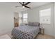 Bedroom with a patterned bedspread, natural light, and a view of the neighborhood at 10144 E Toledo Ave, Mesa, AZ 85212