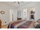 Bright bedroom featuring a walk-in closet, en-suite bathroom, and striped bedspread at 10144 E Toledo Ave, Mesa, AZ 85212