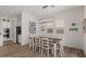 Bright dining area featuring a wooden table with seating for six, accented by a modern light fixture at 10144 E Toledo Ave, Mesa, AZ 85212
