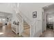 Bright entryway featuring a staircase, decorative table, and open floorplan at 10144 E Toledo Ave, Mesa, AZ 85212