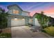 Beautiful two-story home featuring a three-car garage and manicured front lawn at 10144 E Toledo Ave, Mesa, AZ 85212