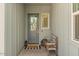 Inviting covered front porch with a cozy bench, stylish lanterns, and a welcoming door at 10144 E Toledo Ave, Mesa, AZ 85212