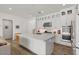 Bright, modern kitchen with a large island, stainless steel appliances, and stylish, white cabinetry at 10144 E Toledo Ave, Mesa, AZ 85212
