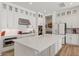 Open kitchen with white cabinets, stainless appliances, a large island, and modern finishes at 10144 E Toledo Ave, Mesa, AZ 85212