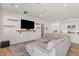 Comfortable living room featuring a large sectional, modern TV setup, and an open layout at 10144 E Toledo Ave, Mesa, AZ 85212