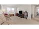 Comfortable living room featuring a plush sofa, natural light, and built-in shelving for storage and display at 10144 E Toledo Ave, Mesa, AZ 85212