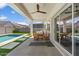 Inviting covered patio with dining area, overlooking a sparkling pool and backyard at 10144 E Toledo Ave, Mesa, AZ 85212