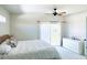 Bright bedroom featuring a ceiling fan, access to balcony, dresser, and neutral decor at 10229 N 12Th Ct # 1, Phoenix, AZ 85020