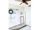 Bright bedroom with a ceiling fan, large windows, a mirror, and a view of the outdoors at 10229 N 12Th Ct # 1, Phoenix, AZ 85020