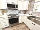 Bright kitchen featuring stainless steel appliances and white cabinets with modern hardware at 10229 N 12Th Ct # 1, Phoenix, AZ 85020
