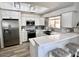 Well-lit kitchen with stainless steel appliances, white cabinets, and breakfast bar at 10229 N 12Th Ct # 1, Phoenix, AZ 85020