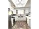 Bright kitchen features white cabinetry, stainless steel appliances, and a stylish backsplash at 10229 N 12Th Ct # 1, Phoenix, AZ 85020