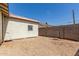 Wide shot of a gravel backyard with a block wall and the exterior of the home at 1029 E Mckinley St, Phoenix, AZ 85006