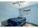 Blue bedroom features built-in shelves, a window, and a ceiling fan at 1029 E Mckinley St, Phoenix, AZ 85006