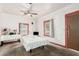 Bedroom featuring a ceiling fan, large windows, and neutral carpeting at 1029 E Mckinley St, Phoenix, AZ 85006