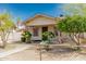 Quaint single-story home featuring mature landscaping and secure chainlink fencing at 1029 E Mckinley St, Phoenix, AZ 85006