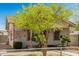 Charming single-story home with a front yard featuring mature trees and decorative bushes at 1029 E Mckinley St, Phoenix, AZ 85006