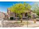 Charming single-story home with a front yard featuring mature trees and decorative bushes at 1029 E Mckinley St, Phoenix, AZ 85006
