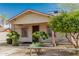 Charming home with mature landscaping, secure fencing, and architectural details at 1029 E Mckinley St, Phoenix, AZ 85006