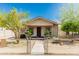 A cozy single-story home with mature trees, bushes and a fenced front yard at 1029 E Mckinley St, Phoenix, AZ 85006