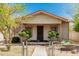 Charming exterior view of the home with a fenced yard and mature landscaping at 1029 E Mckinley St, Phoenix, AZ 85006