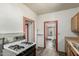 View of the kitchen leading to the dining room with a white gas range at 1029 E Mckinley St, Phoenix, AZ 85006