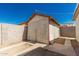Wooden shed with a graying exterior and metal roof with a wood plank door at 1029 E Mckinley St, Phoenix, AZ 85006