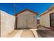 Outdoor shed with wooden doors and a concrete driveway in the backyard at 1029 E Mckinley St, Phoenix, AZ 85006