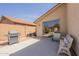 Cozy back patio with seating, a grill, and desert landscaping, perfect for outdoor gatherings at 10346 E Desert Dawn Dr, Gold Canyon, AZ 85118