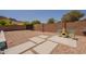 Spacious backyard with desert landscaping, concrete path, chairs, and mountain views, ideal for outdoor living at 10346 E Desert Dawn Dr, Gold Canyon, AZ 85118