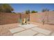 Desert landscaped backyard featuring chairs, a fire pit, and a concrete tile path, ideal for outdoor enjoyment at 10346 E Desert Dawn Dr, Gold Canyon, AZ 85118