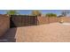Backyard gate area featuring desert landscaping, providing a blank canvas to create your outdoor oasis at 10346 E Desert Dawn Dr, Gold Canyon, AZ 85118
