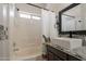 Bright bathroom with double sinks, decorative tile, and a tub with shower at 10346 E Desert Dawn Dr, Gold Canyon, AZ 85118