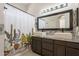Stylish bathroom featuring double sinks, granite countertop, and decorative cactus shower curtain at 10346 E Desert Dawn Dr, Gold Canyon, AZ 85118